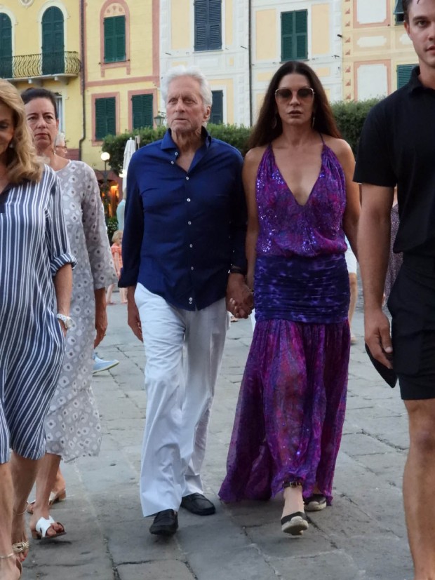 Catherine Zeta-Jones Glitters in Purple Dress on Romantic Stroll With Husband Michael Douglas all-available